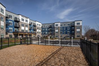 A playground area in front of a row of townhouses.